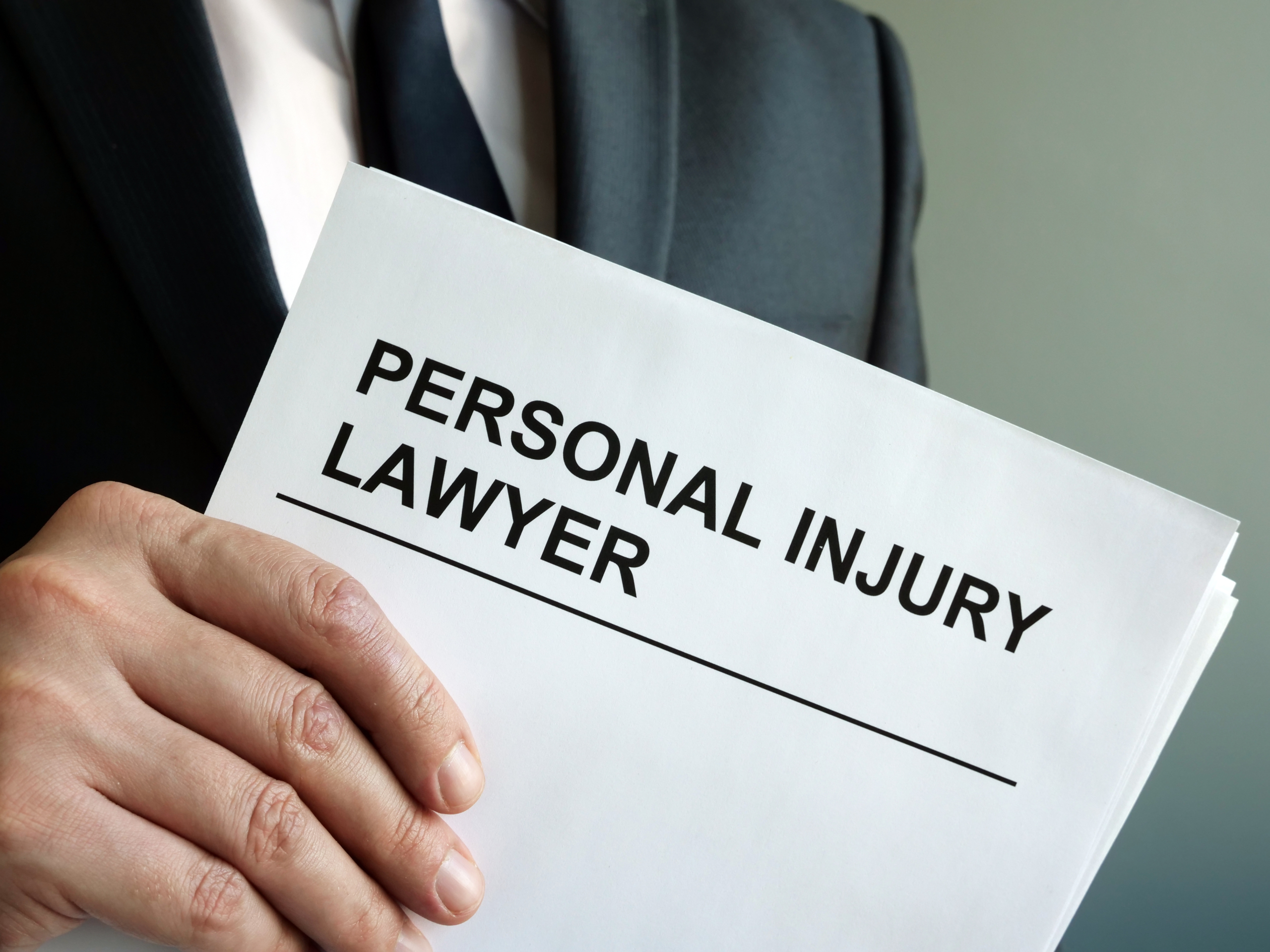Personal injury lawyer building winning case - attorney reviewing evidence with legal team
